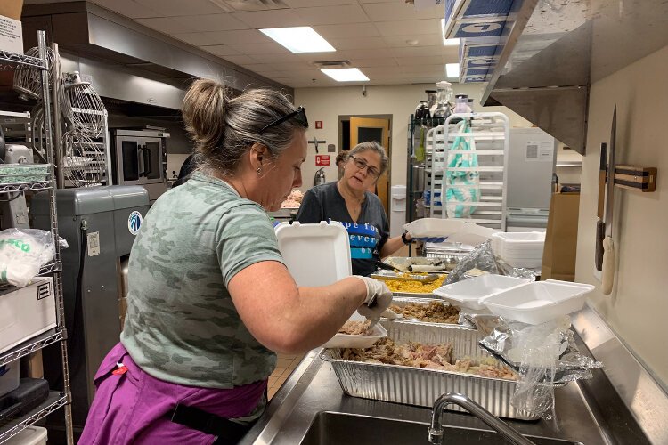 Volunteers with South Tampa Fellowship prepare meals for Afghan refugees who have settled in Tampa Bay.