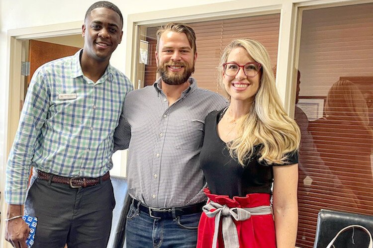 Real estate agent Sherman Milton III with millennial homebuyers Cody and Erin Parks.
