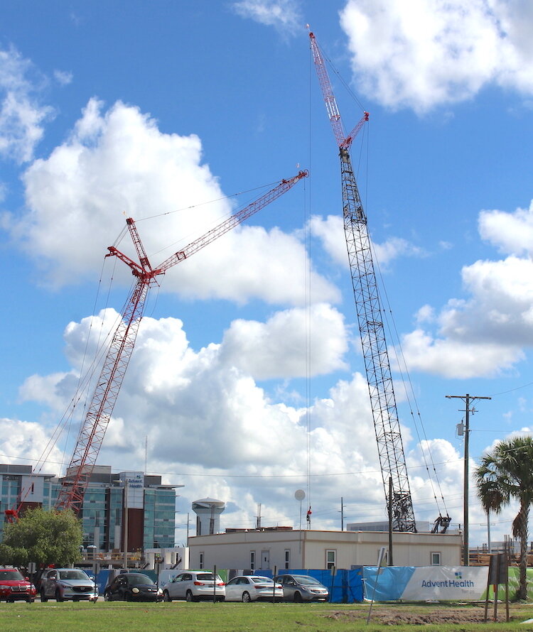 Two cranes are working in tandem along with a talented team of workers who are helping build a state-of-the-art medical tower at AdventHealth Hospital in the Uptown District. 