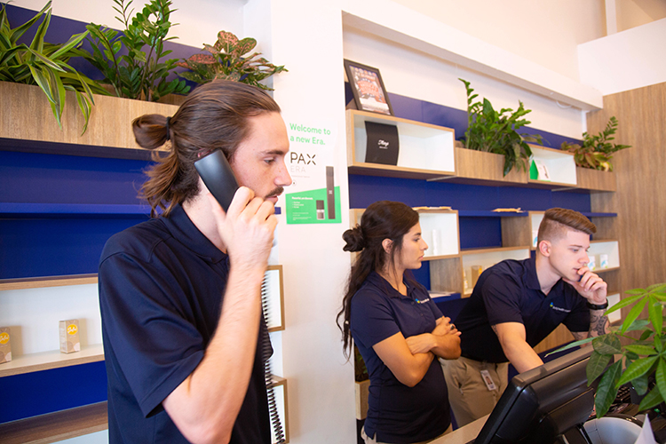 Graham Johnson assists a customer at the Liberty Health Sciences medical marijuana dispensary in St. Pete.