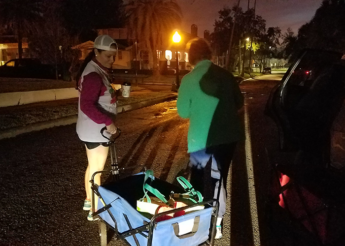 With only the light from their car's headlamps, Meaghan Hoy and Kem Toole, begin the long pre-dawn trek to deliver food, water, blankets, and books to the homeless of Tampa. 