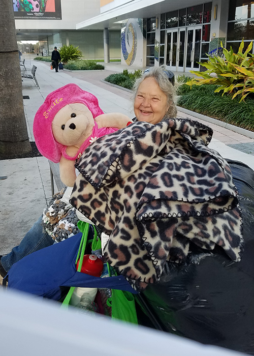 Diana, and her constant companion "Smile Bear," offers her own warm smile to the Kindness Matters volunteers. 