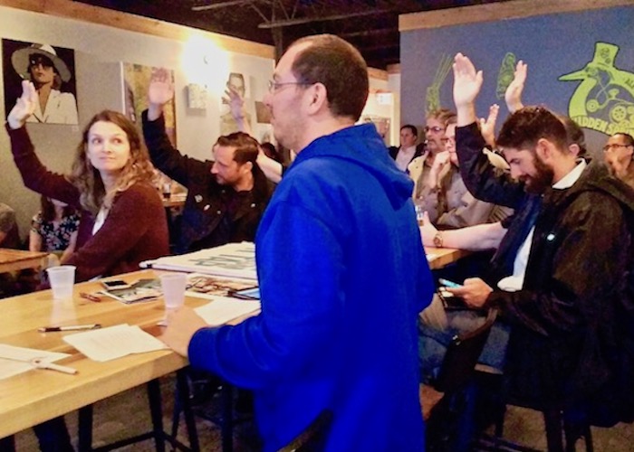 Hands shoot up during an Urbanism on Tap workshop as people share their ideas and hopes for future development in Tampa Heights and the Yellow Brick Row business district.