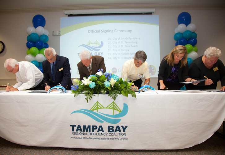 Tampa Bay officials sign in to create the new coalition to address sea level rise, climate change, and resiliency.