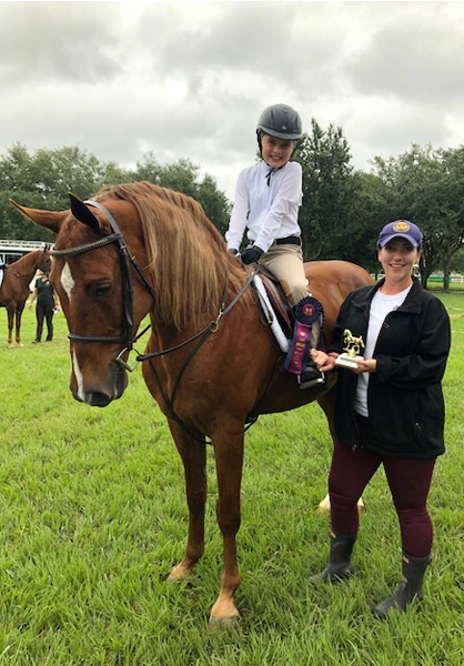 Scout Bendickson and Sheila Steis, founder of Selah East Stables, celebrate a first-place win with Hercules, a slaughter-bound saddlebred the Bendickson family adopted in March.