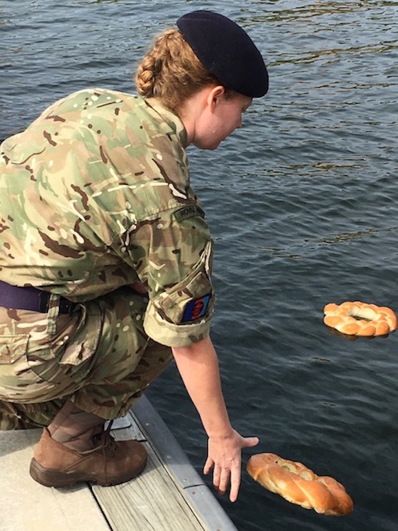 Lt. Cmdr. Laura Holt of the British Royal Navy lays a wreath honoring the USS Tampa.