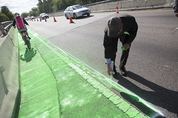 Richard Retting, a consultant with Sam Schwartz Engineering, takes part in Paint Saves Lives.