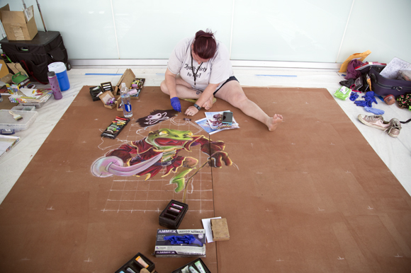 Artist Bridget Lyons works on a chalk design at Gasparilla Festival of the Arts.