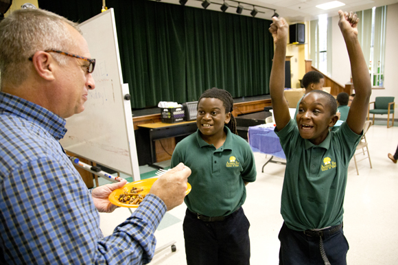 Academy Prep Center of Tampa Head of School Lincoln Tamayo samples a dish made by students.