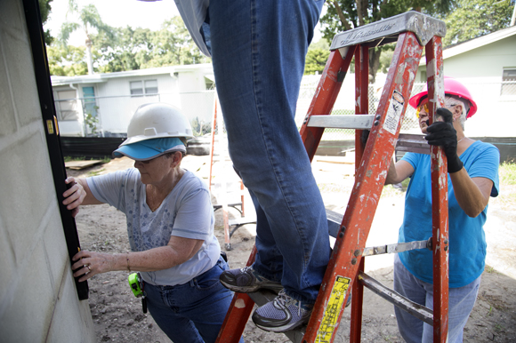 Ellen Poniewaz (left) and Nancy Doherty (right),  volunteer from St Michaels The Archangel Catholic Church, works on the Acevedo family home.