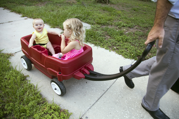 Leona and Sienna are pulled by their father Ara.