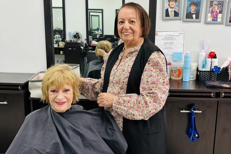 Business owner and hairdresser Carmen Conrad, seen here with longtime customer Marilyn Shaw, has become a fixture in Land O’ Lakes.