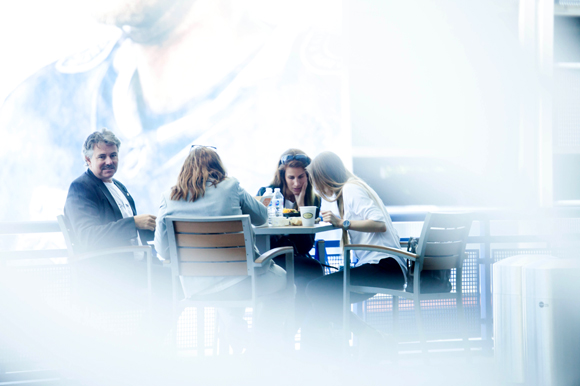 Guests sit outside during lunch provided by Inside the Box Catering at Amalie Arena.