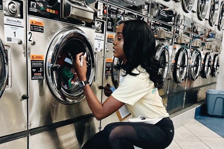 Laundry Project volunteers help community members with their wash and temporarily transform laundromats into community centers