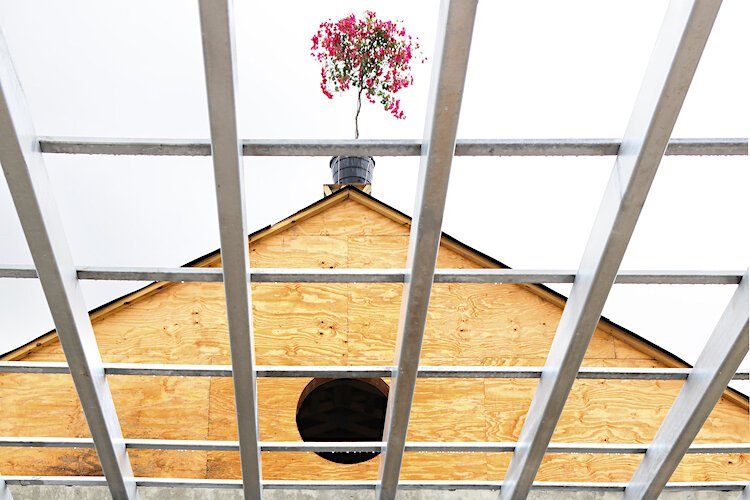 Resilient Retreat's topping-off ceremony is based in a Scandinavian tradition of placing an evergreen tree at the highest point of the building's structural skeleton. The Retreat put a tropical twist on tradition with a vibrant Bougainvillea plant.