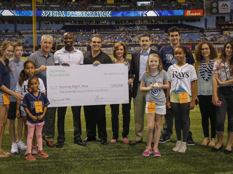 Representatives from Humana present a $350,000 check to Starting Right, Now at a Tampa Bay Rays game